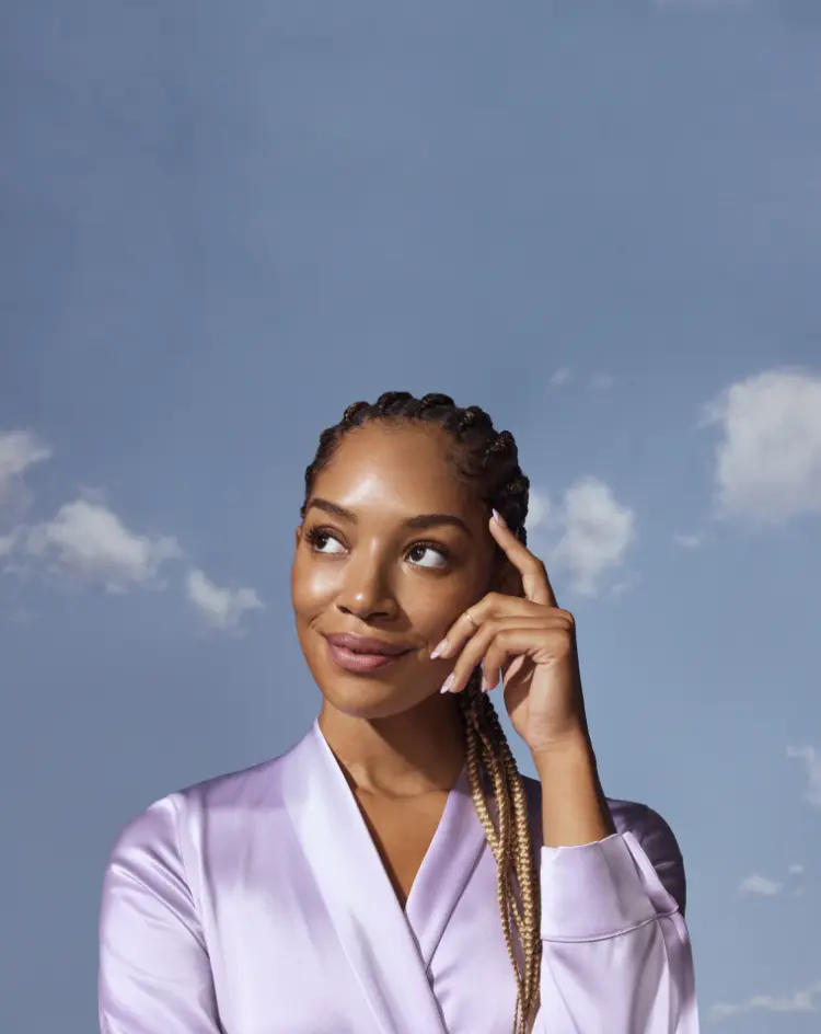 Smiling woman standing in front of a sky view
