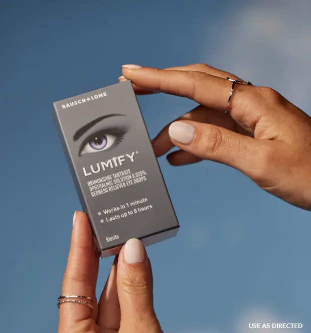 Pair of hands holding up a box of Lumify redness reliever eye drops