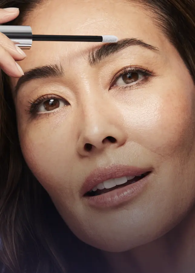 Woman applying Lumify lash and brow serum