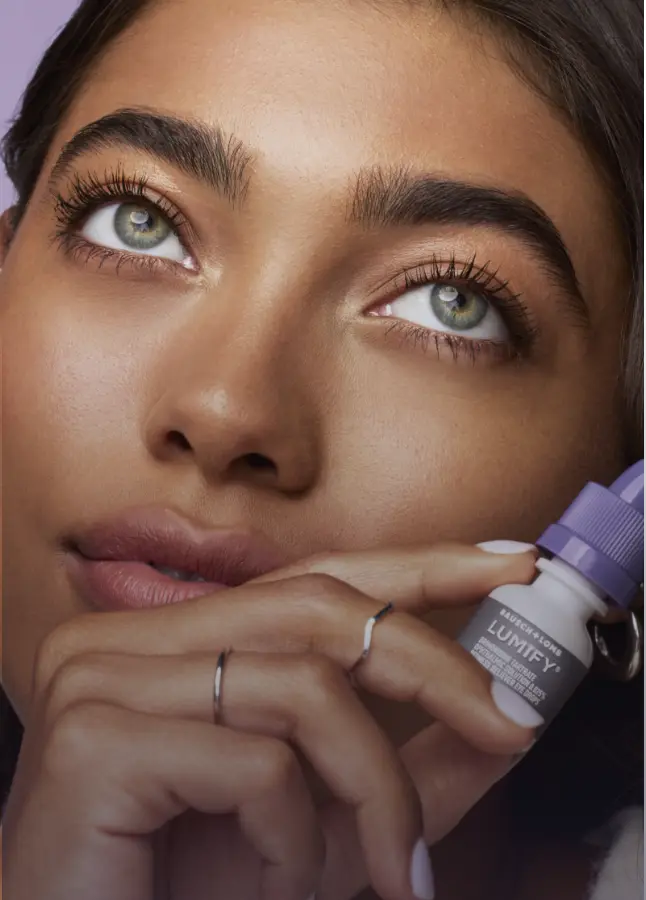 Woman holding Lumify redness reliever eye drops