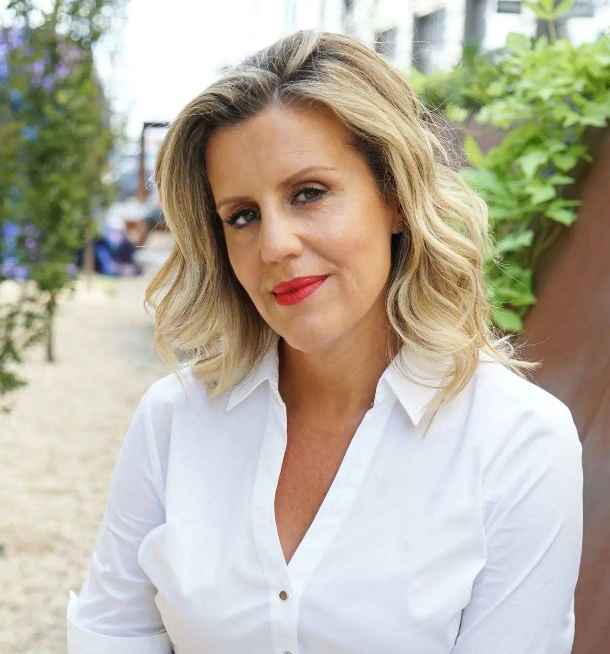 Erica Whelan, a white woman in her 30s is smiling.