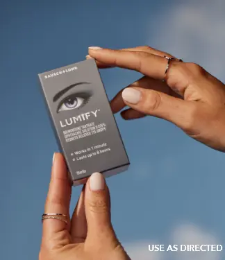 Pair of hands holding a box of Lumify redness relieving eye drops